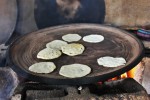 Tortillas cooking on an open fire