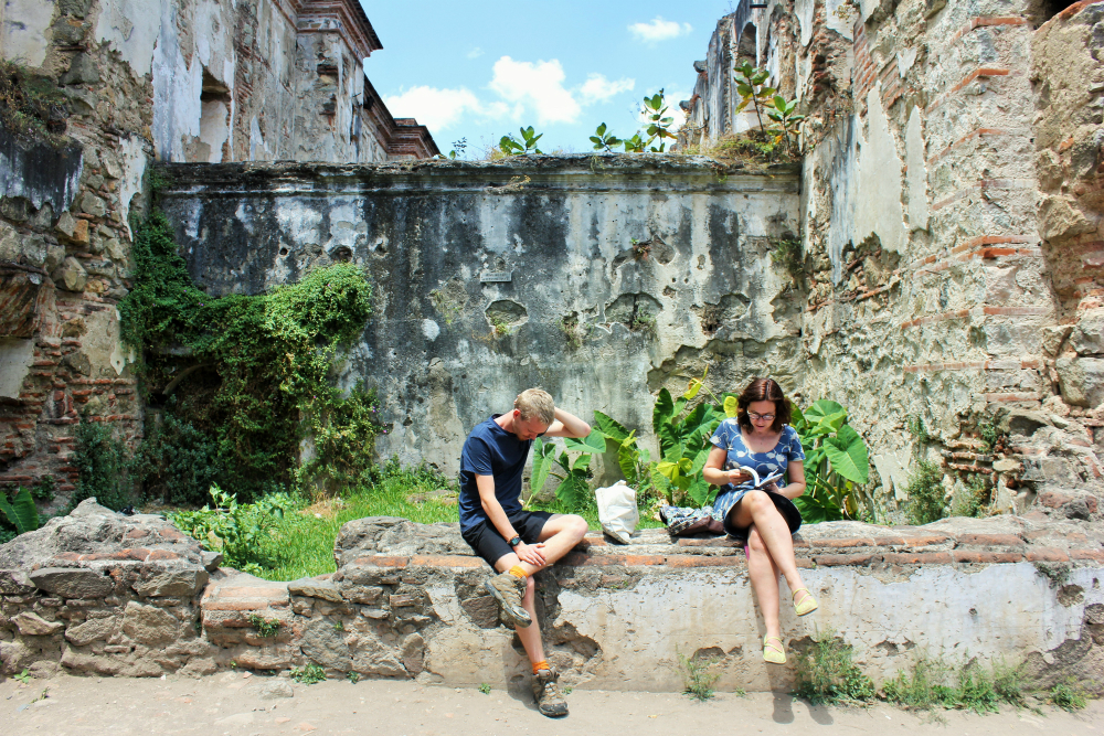 Luke and Julia on wall in Antigua Guatemala - Charlie on Travel