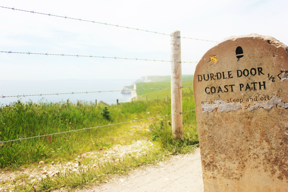 Lulworth Cove England Durdledoor sign - Charlie on Travel