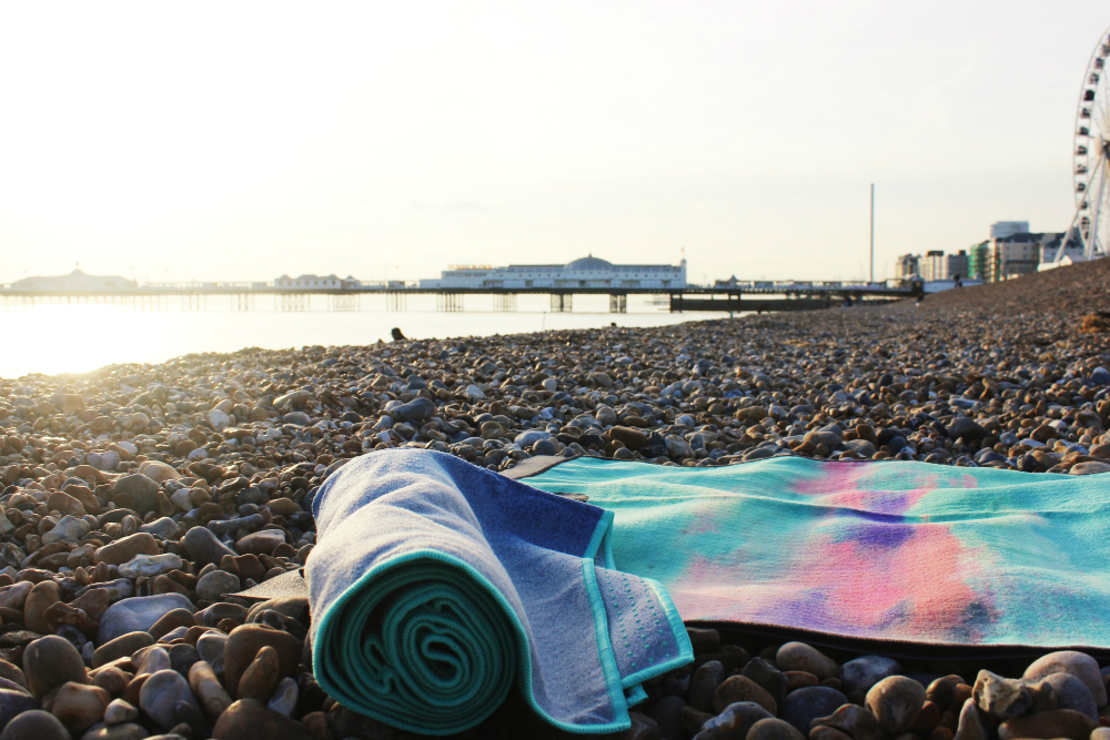 Stay healthy and keep fit while travelling - Manduka Yoga mat on beach - Charlie on Travel