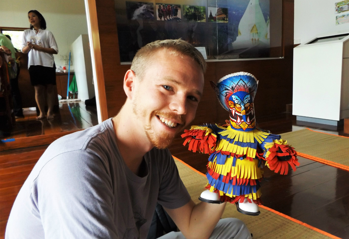 Luke and a puppet at Phi Ta Khon Festival Thailand - Loei - Charlie on Travel