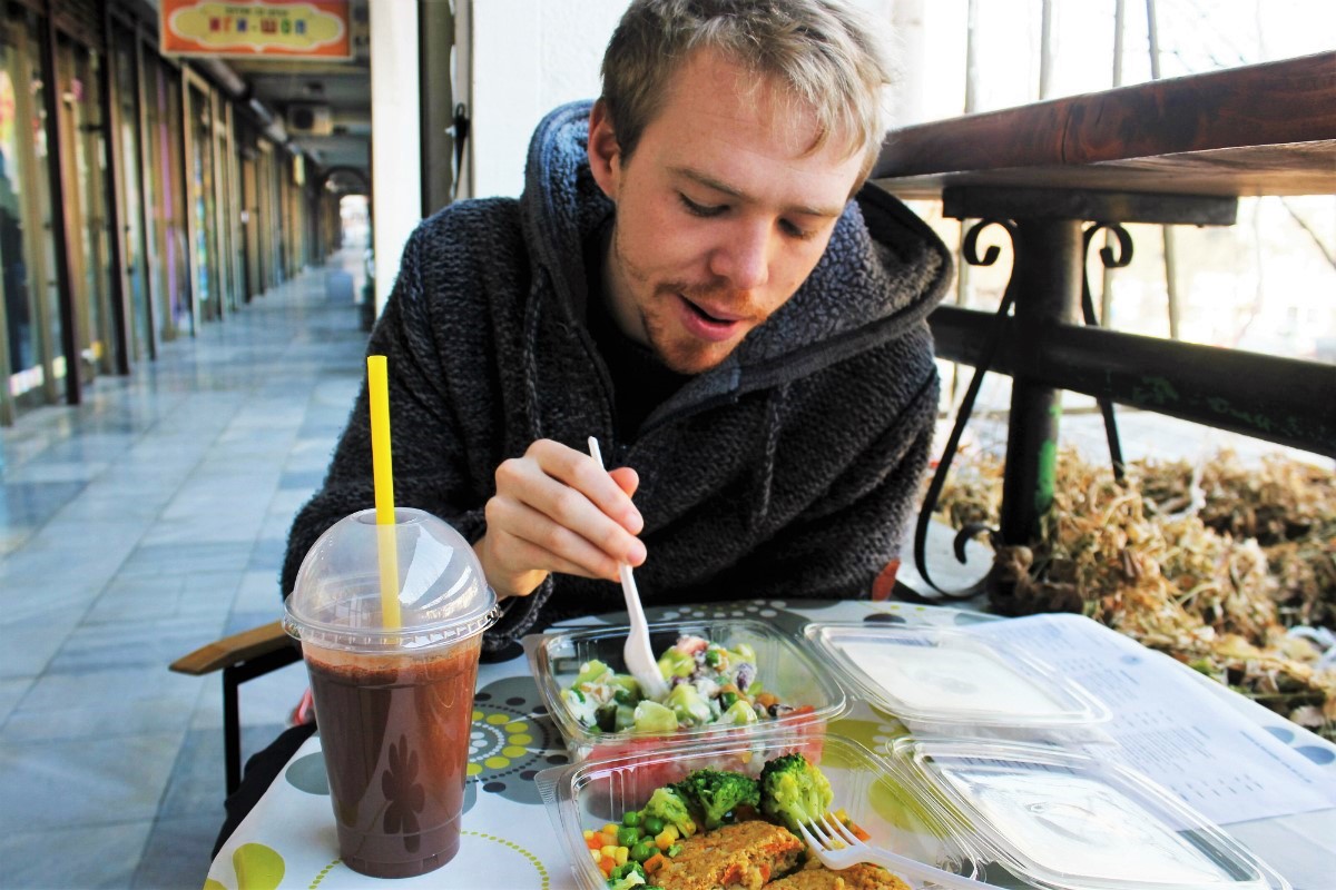 Vegan in Skopje Macedonia - Luke eating at raw food cafe - Charlie on Travel