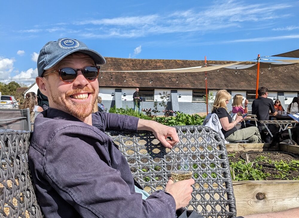 Luke drinking a glass of Sussex wine at Artelium vineyard near Brighton